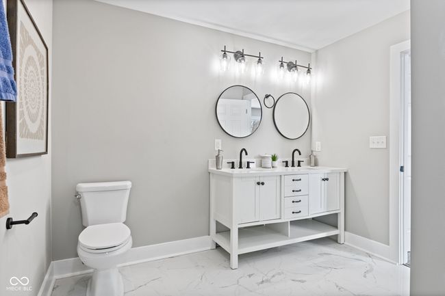 Primary bathroom with marble finish floor, baseboards, and a sink | Image 22