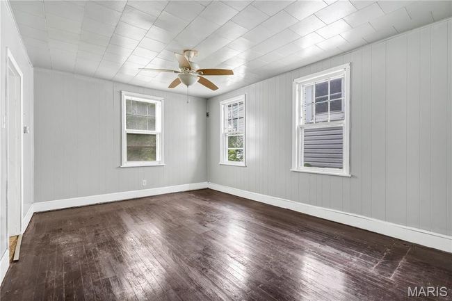 Spare room featuring hardwood / wood-style floors and a ceiling fan | Image 8