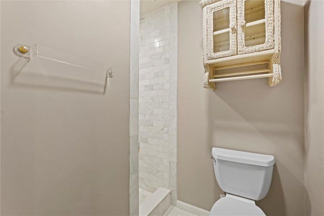 Bathroom featuring toilet and a tile shower | Image 17