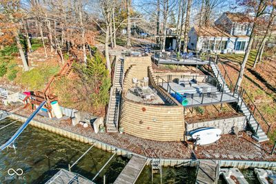 Tan brick retaining wall with steps to the left that lead to the home. | Image 3