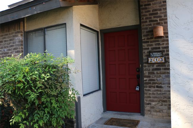View of exterior entry featuring stucco siding and brick siding | Image 8
