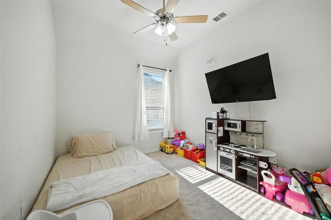 Carpeted bedroom with ceiling fan | Image 26