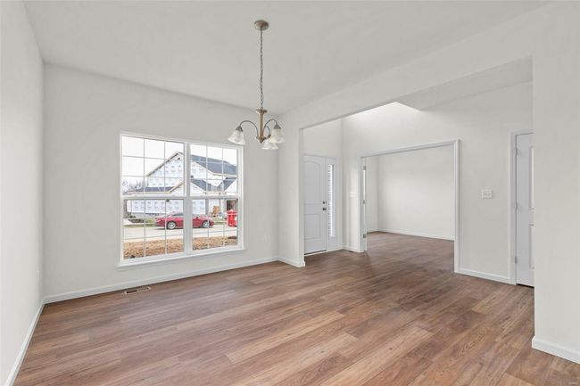 Unfurnished dining area featuring hardwood / wood-style floors and a chandelier | Image 27