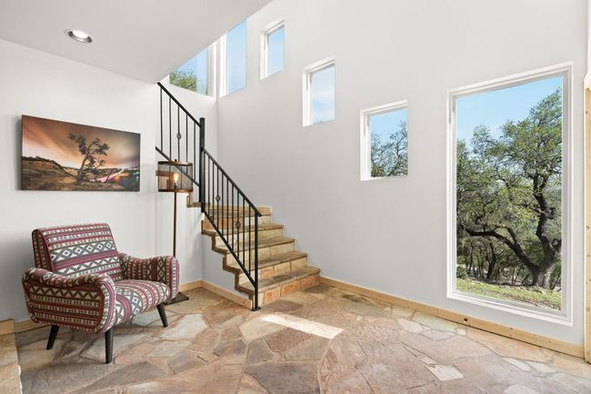 Lower level entryway with steps leading up the main family room. | Image 21