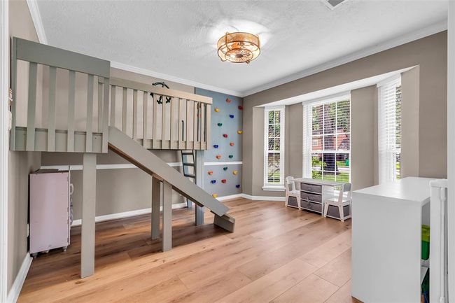 The dining room is currently being used as a playroom, featuring a built-in playhouse and rock wall. | Image 23