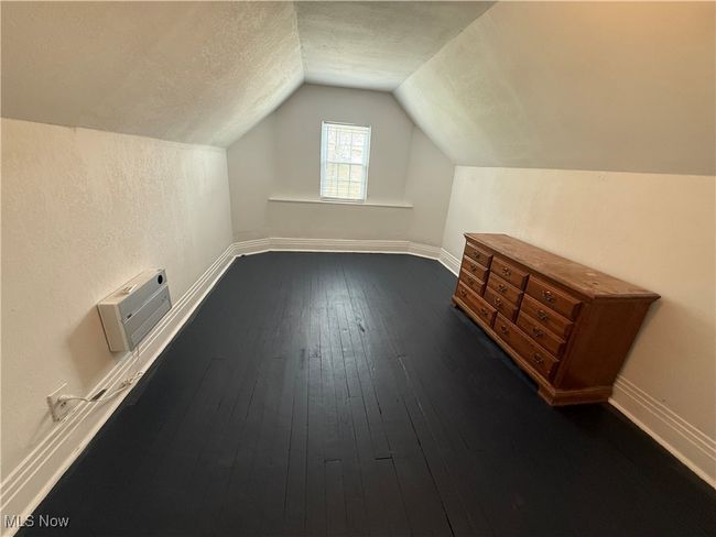 Additional living space with lofted ceiling, a textured ceiling, dark wood finished floors, and baseboards | Image 7