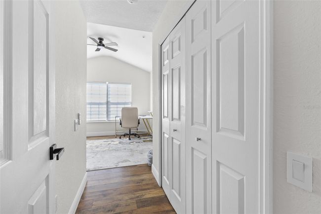 Hallway to guest bedroom 3 with a laundry closet to the right | Image 18