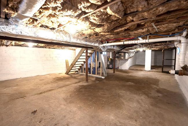 Unfinished below grade area with heating unit and stairs | Image 32
