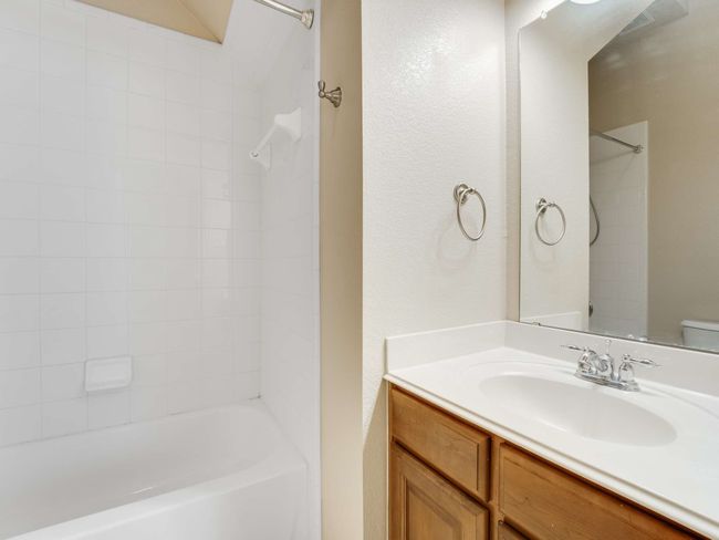 Full bathroom featuring vanity, shower / bath combination, and a textured wall | Image 18