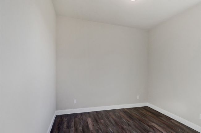 Spare room with baseboards and dark wood finished floors | Image 13