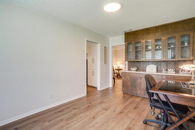 Office area featuring a textured ceiling and light wood-type flooring | Image 21