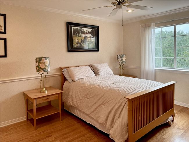 Bedroom featuring crown molding, baseboards, ceiling fan, and wood finished floors | Image 28