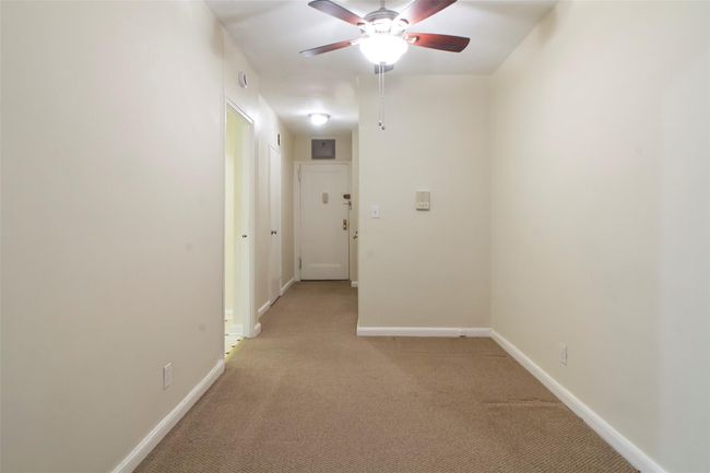 Empty room featuring light colored carpet and a ceiling fan | Image 13