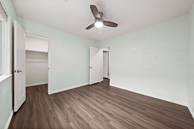 Unfurnished bedroom with baseboards and wood finished floors | Image 18