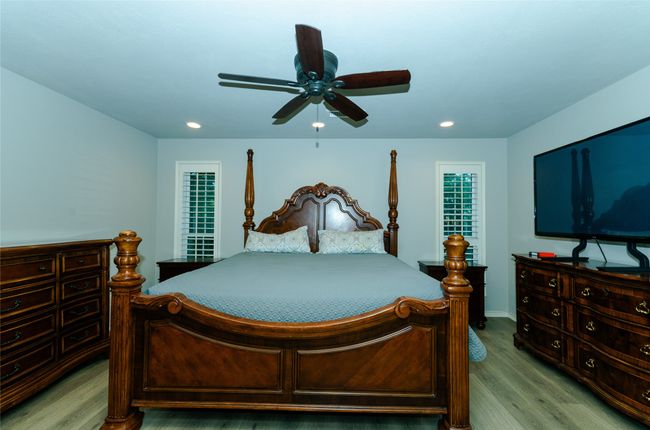 Bedroom with ceiling fan, wood finished floors, and recessed lighting | Image 13
