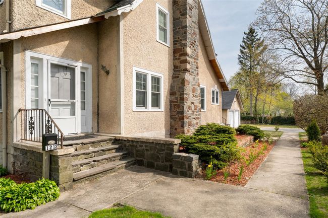View of home's exterior featuring stone siding and stucco siding | Image 19