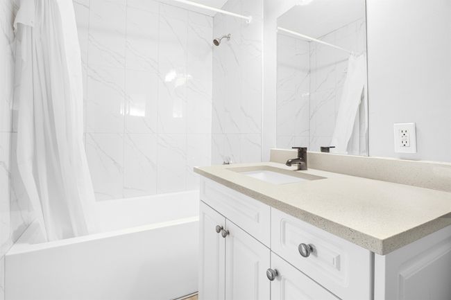 Bathroom featuring shower / bathtub combination with curtain and vanity | Image 16