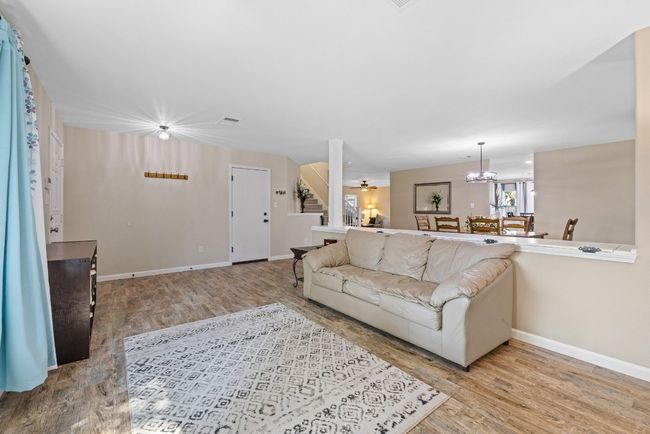 This formal living room flows seamlessly into the rest of the home, making it perfect for entertaining or relaxing. | Image 16