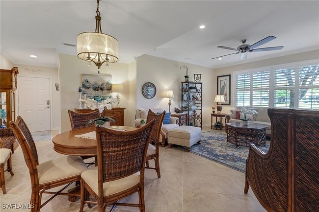 Dining room with baseboards, recessed lighting, crown molding, and ceiling fan with notable chandelier | Image 9