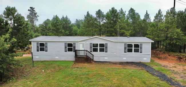 View of front facade with crawl space and a front lawn | Image 4