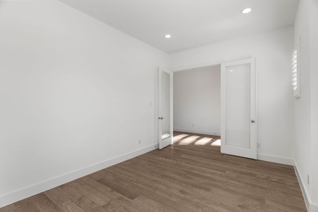 Unfurnished room featuring wood finished floors, baseboards, and recessed lighting | Image 8
