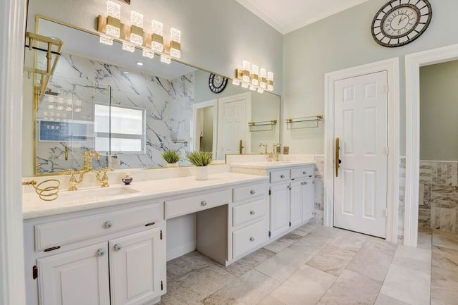 Primary ensuite features a double vanity, tile flooring, a private water closet, and large walk-in closet | Image 14
