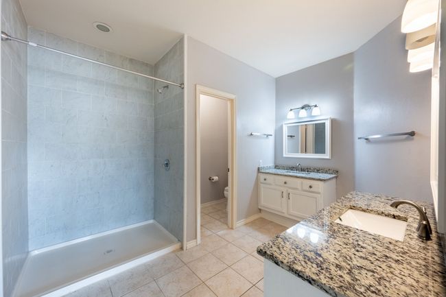Full bath with vanity, tile patterned flooring, and a tile shower | Image 16