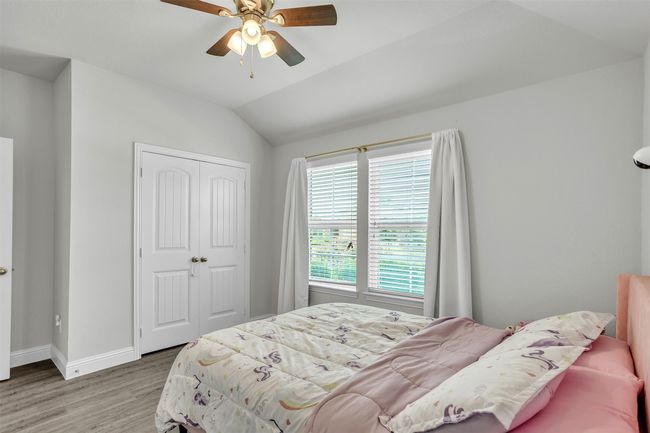 Bedroom featuring wood finished floors, a closet, lofted ceiling, and ceiling fan | Image 18