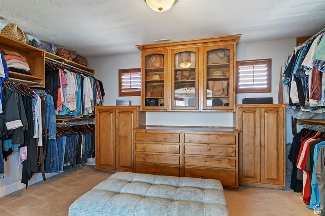 Spacious closet featuring light colored carpet | Image 35