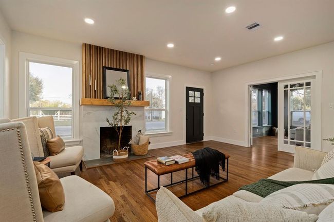 This spacious family room seamlessly connects to the formal living area (or potential home office) located just beyond the French doors. | Image 7