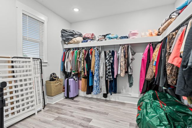 Walk in closet with wood finished floors | Image 14