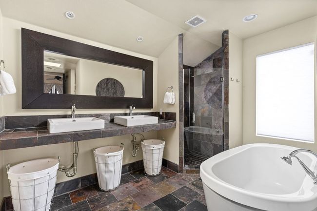 Upstairs Full bathroom featuring a freestanding tub, shower, and stone tile floors | Image 17