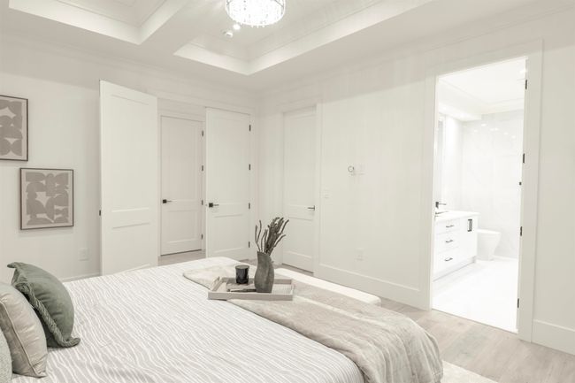 Bedroom featuring light wood-style flooring, crown molding, ensuite bathroom, and baseboards | Image 14