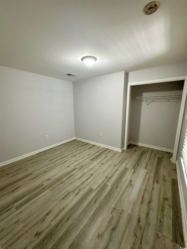 Unfurnished bedroom featuring a closet, light wood-type flooring, and baseboards | Image 20