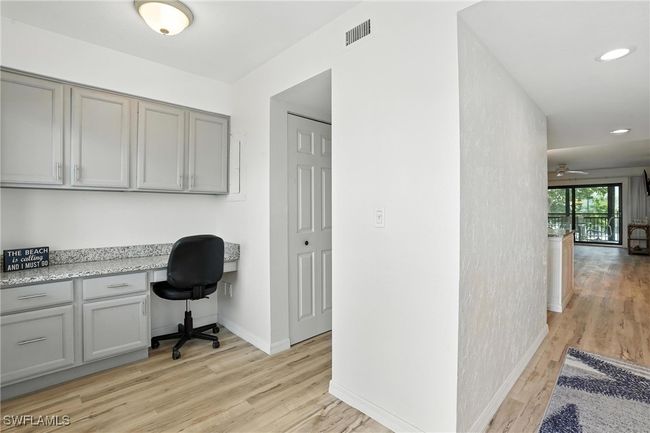 Home office with built in desk, light wood-type flooring, recessed lighting, and ceiling fan | Image 19