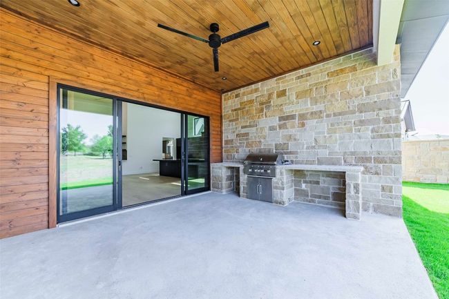 Large covered outdoor living space with cook area | Image 4