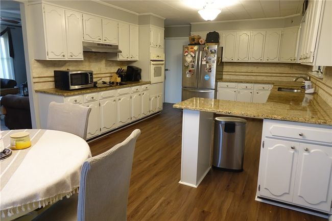 Fully equipped kitchen with abundant countertop space and cabinetry | Image 8