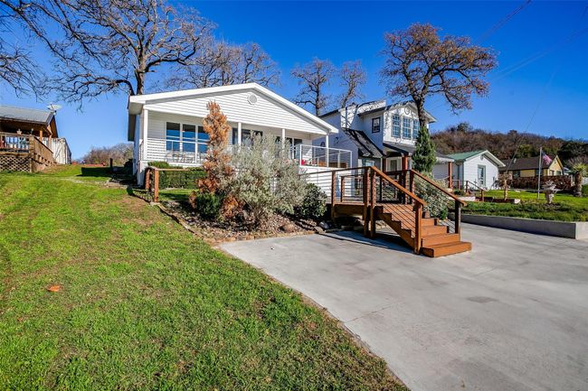 Rear view of house featuring a yard, covered porch, and stairs | Image 34