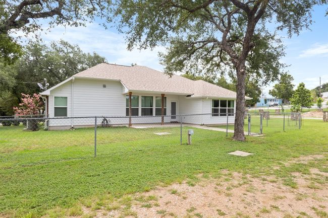 Rear view of house with a fenced back yard | Image 5