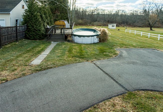 View of yard with a pool side deck and a storage unit | Image 29