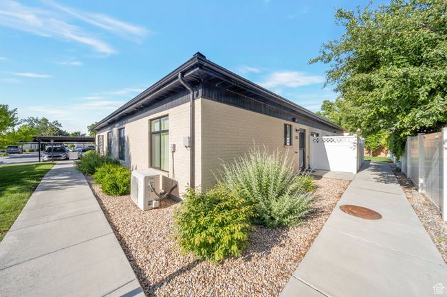 View of side of home with brick siding and a cooling unit | Image 15