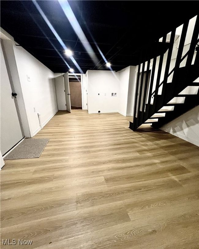Finished below grade area with stairs, light wood-type flooring, and baseboards | Image 20
