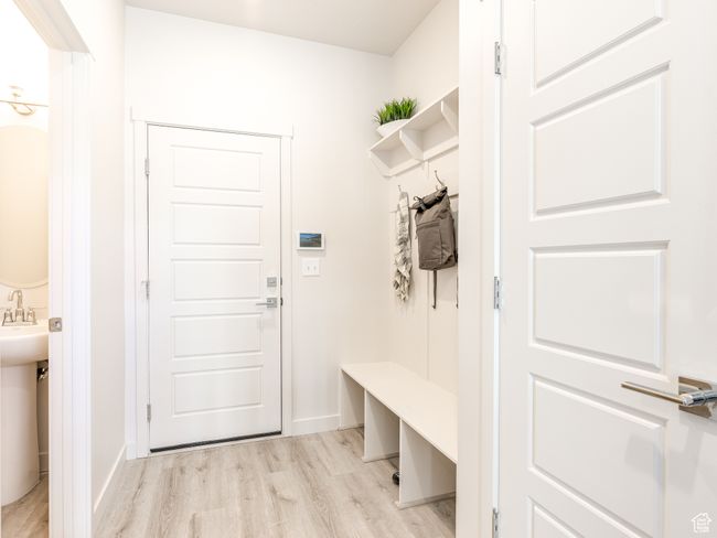 Mudroom featuring light wood-style floors and baseboards | Image 19