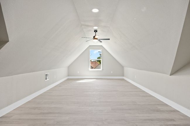 Additional living space with a ceiling fan, visible vents, lofted ceiling, light wood finished floors, and baseboards | Image 18