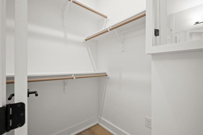 Spacious closet with wood finished floors | Image 22