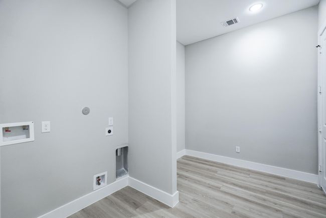 Dedicated utility room with built-in storage and washer/dryer connections | Image 34