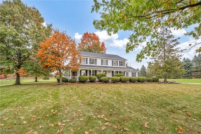 Colonial home featuring a porch and a front lawn | Image 3