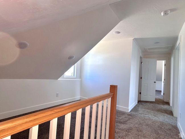 Hall featuring an upstairs landing, carpet, and baseboards | Image 18