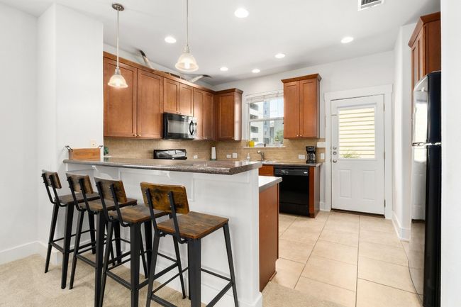 This kitchen also has easy access to your detached 1-car garage which means bringing in groceries is an absolute breeze | Image 9