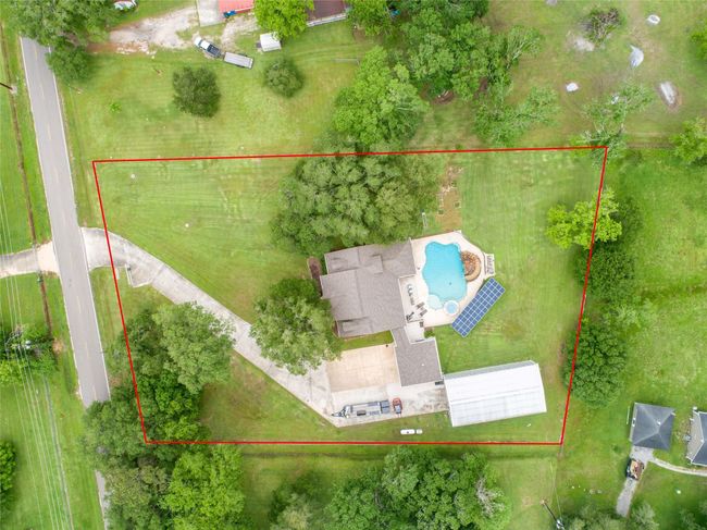 Tucked away on 1.5 serene acres in Manvel, this distinctive property is built for the way you want to live. The flexible floorpan allows between 4 to 6 bedrooms, 2.5 baths, a 2-car garage, in-ground pool, plus a 60'x30' insulated shop. | Image 47